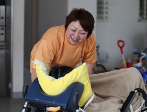 車椅子の利用者に話しかけるヘルパー